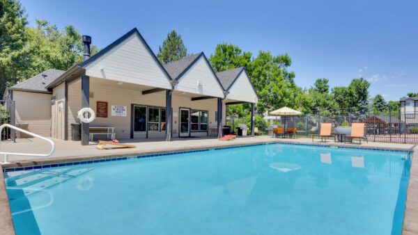 pool with clubhouse and cornhole boards