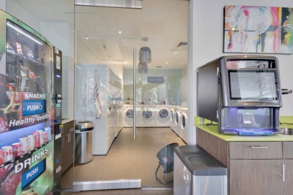 view of laundry room entrance with vending machine