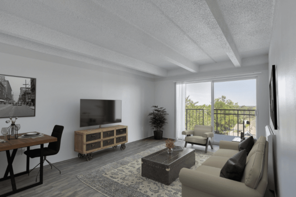 living room with balcony, tv, and dining table