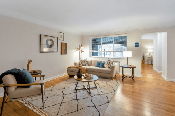 living room with couch and coffee table with large window