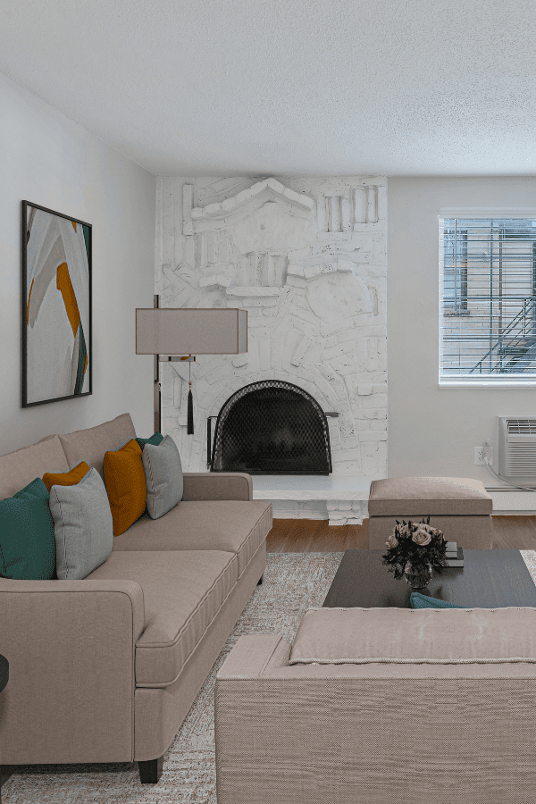 living room with couch, brick fire place, and coffee table