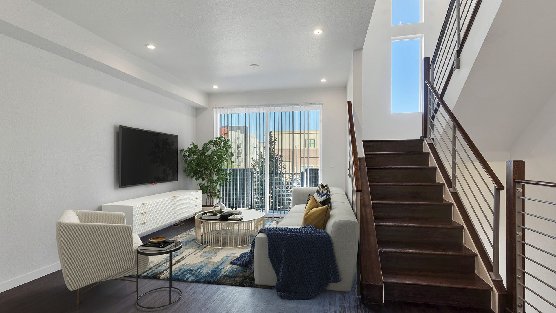 Rendering of stairs leading down into a living room with wood floors and patio doors.