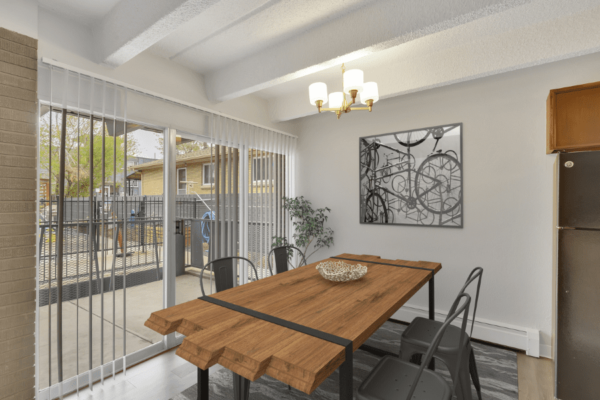 dining area with wooden table and four chairs looking out to patio
