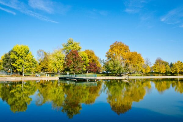 Photo of fall trees reflecting on the water at Wash Park