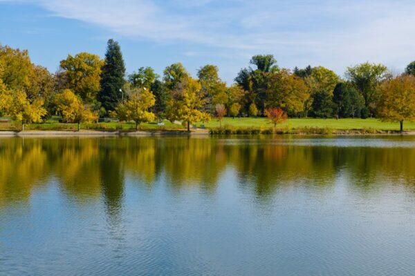 Photo of fall trees reflecting on the water at Wash Park