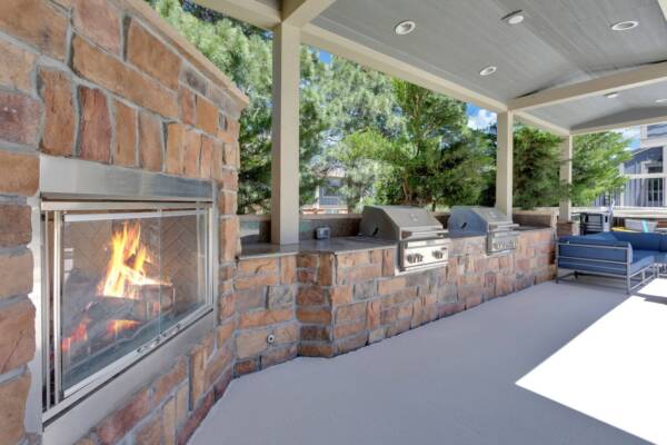 The swimming area includes a covered grilling area with fireplace