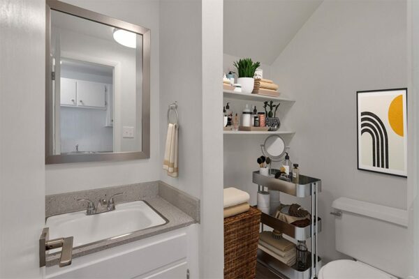 Rendering of a furnished bathroom with gray walls, white cabinets, and gray countertops.