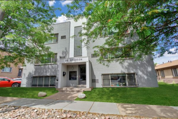 25 Emerson with grey brick construction, tall trees, and classic mid century style.