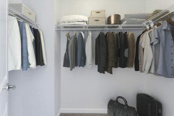 Rending of a large closet with white walls and shelving.