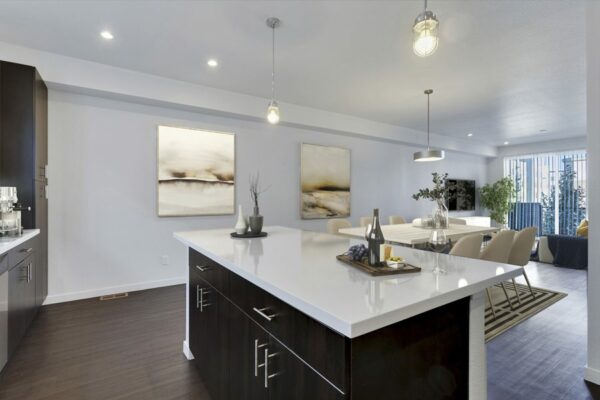 Rendering of a kitchen with a large island, dark wood cabinets, and white countertops.