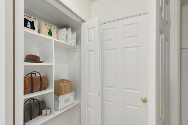 Rendering of a closet with shelving and white walls.