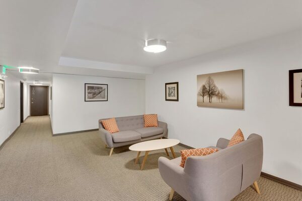 Lounge with plush couches and framed artwork.