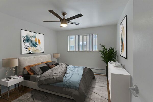 Bedroom with plush bed, bedside tables with lamps, and ceiling fan.