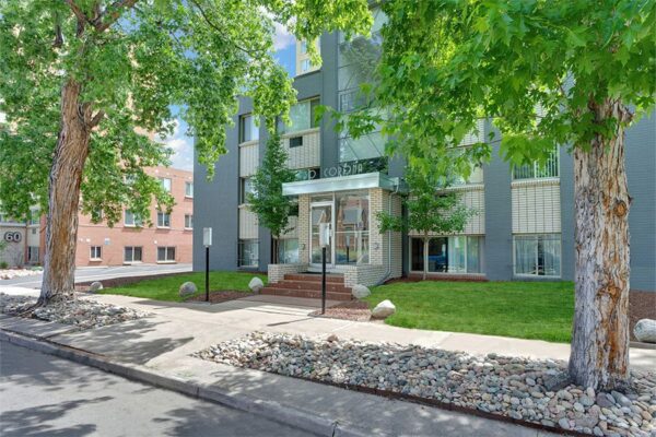 50 Corona apartments with grey brick construction, art deco styling, and ample parking.