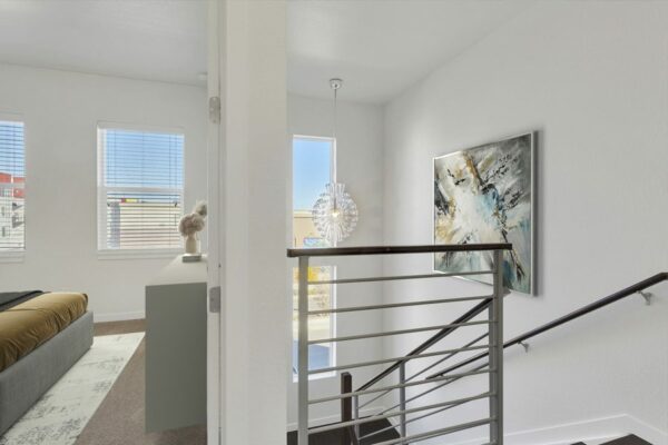 Rendering of a stairway leading into a bedroom with carpet and large windows.