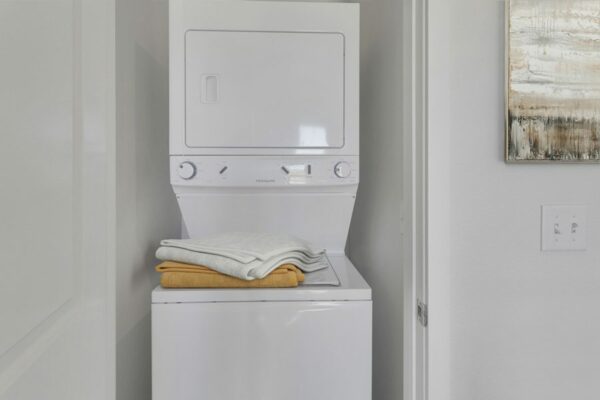 Rendering of a laundry room with a stacked washer & dryer.