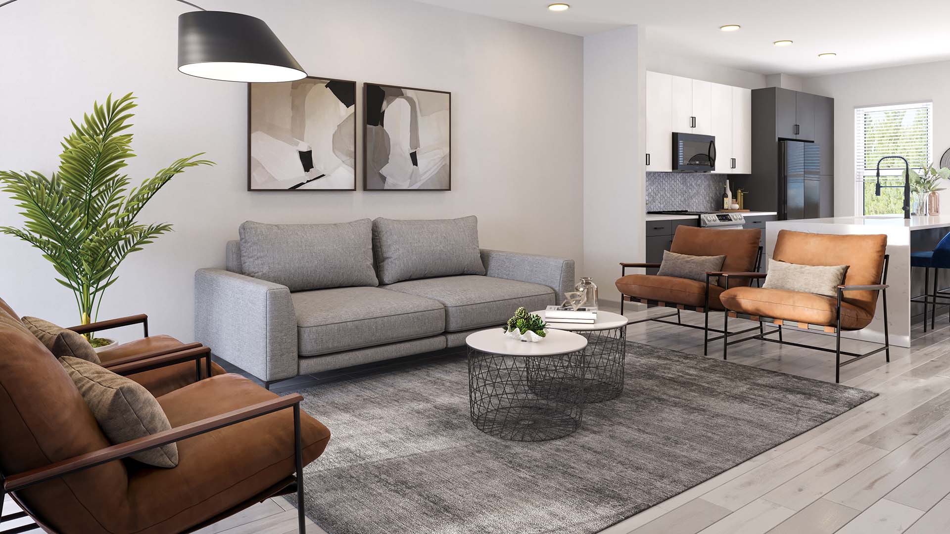 Living room with plush seating, framed artwork, large plant, and ceiling fan.