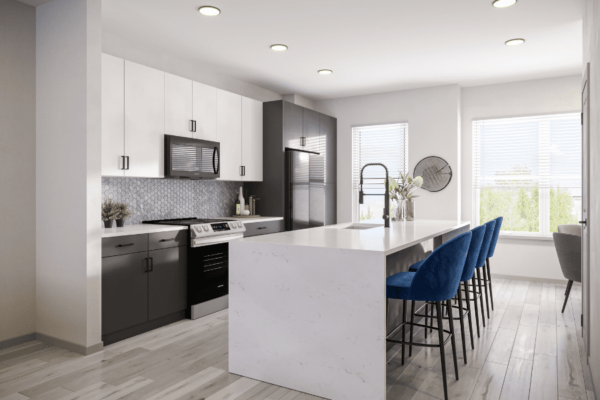 Large kitchen with waterfall countertop island with soft closing cabinets, oven range and fridge in the background