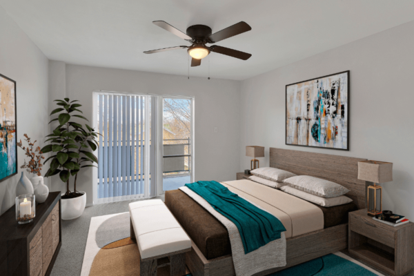 One-Bedroom apartment with Bed in focus and balcony in background