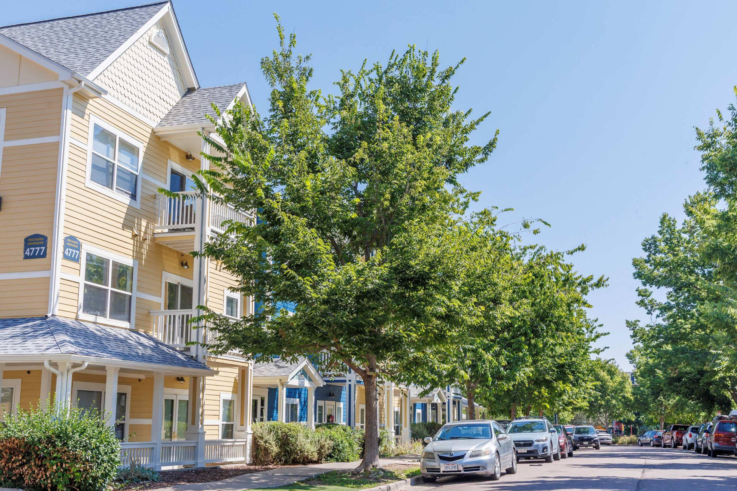 yellow building with trees lining the streets