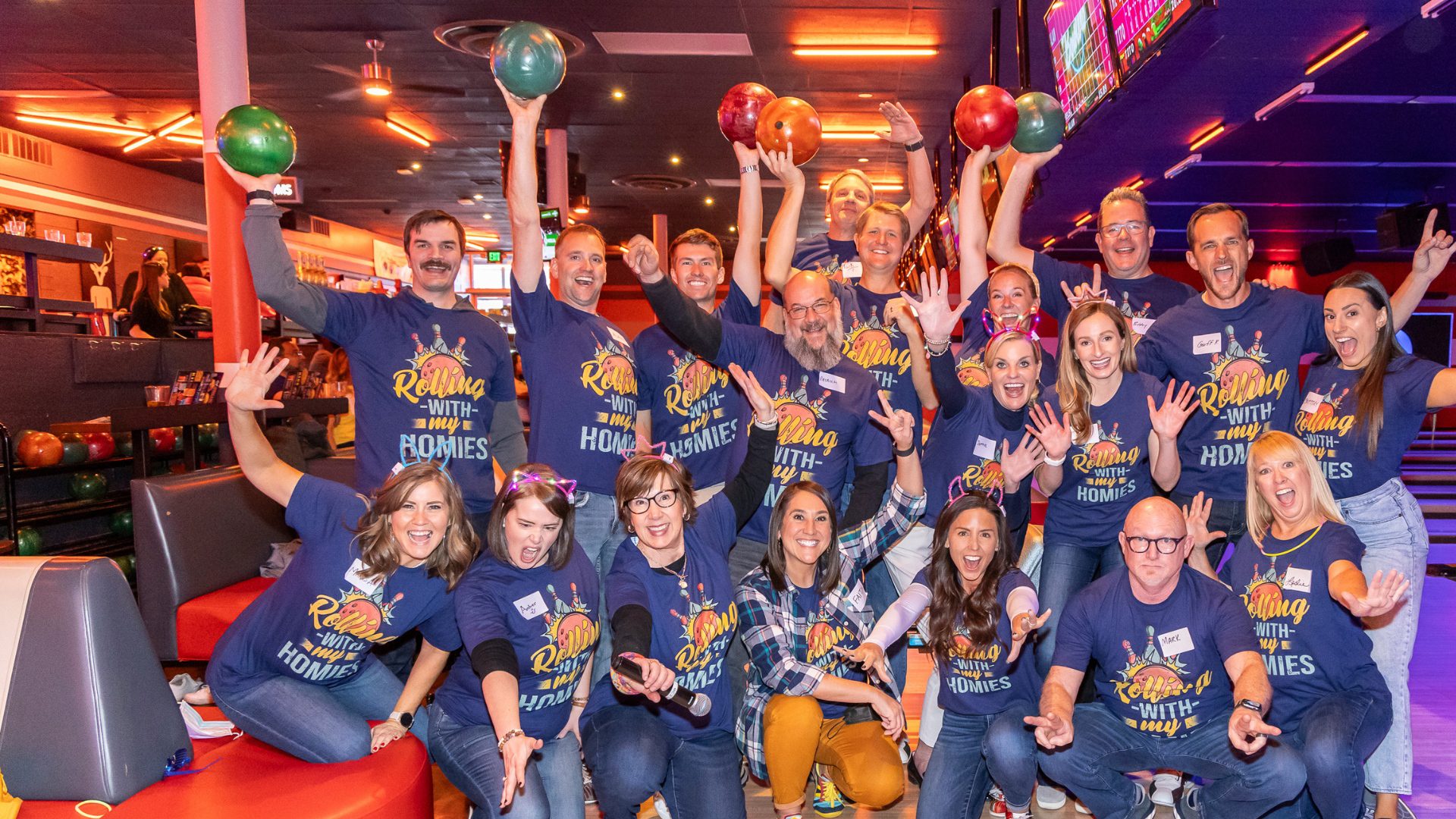 people posing for a photo in a bowling ally