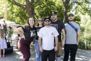 group of friends posing near the monkeys at he zoo