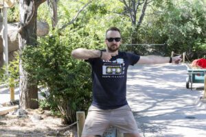 man pointing in direction of traffic for people to follow