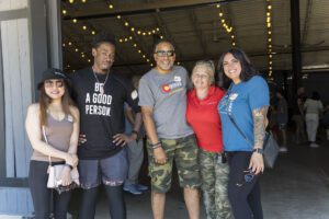 five team members posing for photo at the zoo