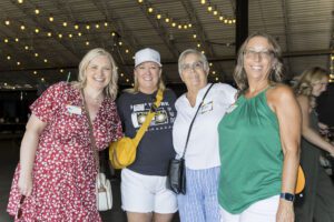 four women gathering for photo