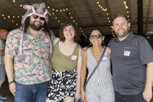 four people posing for photo at the zoo