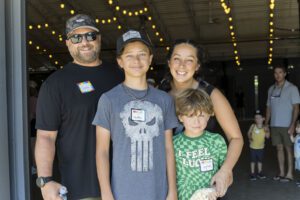 family of four posing for picture