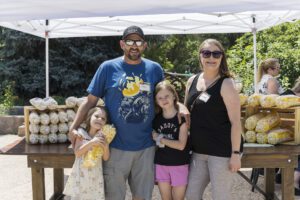 family of four posing for photo near table of popcorn