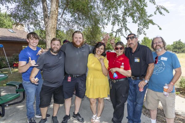 RedPeak employees smiling and posing together at social event.