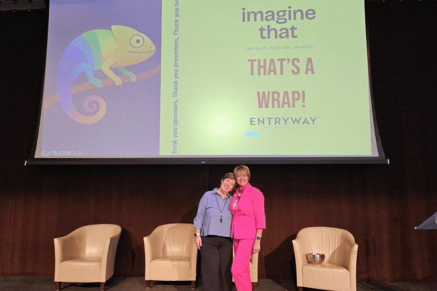 Lori Snider and Robin Cue standing on stage after the Entryway event